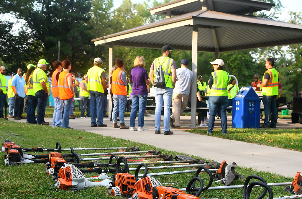Workers gather for announcements before splitting into work crews on Friday during Operation